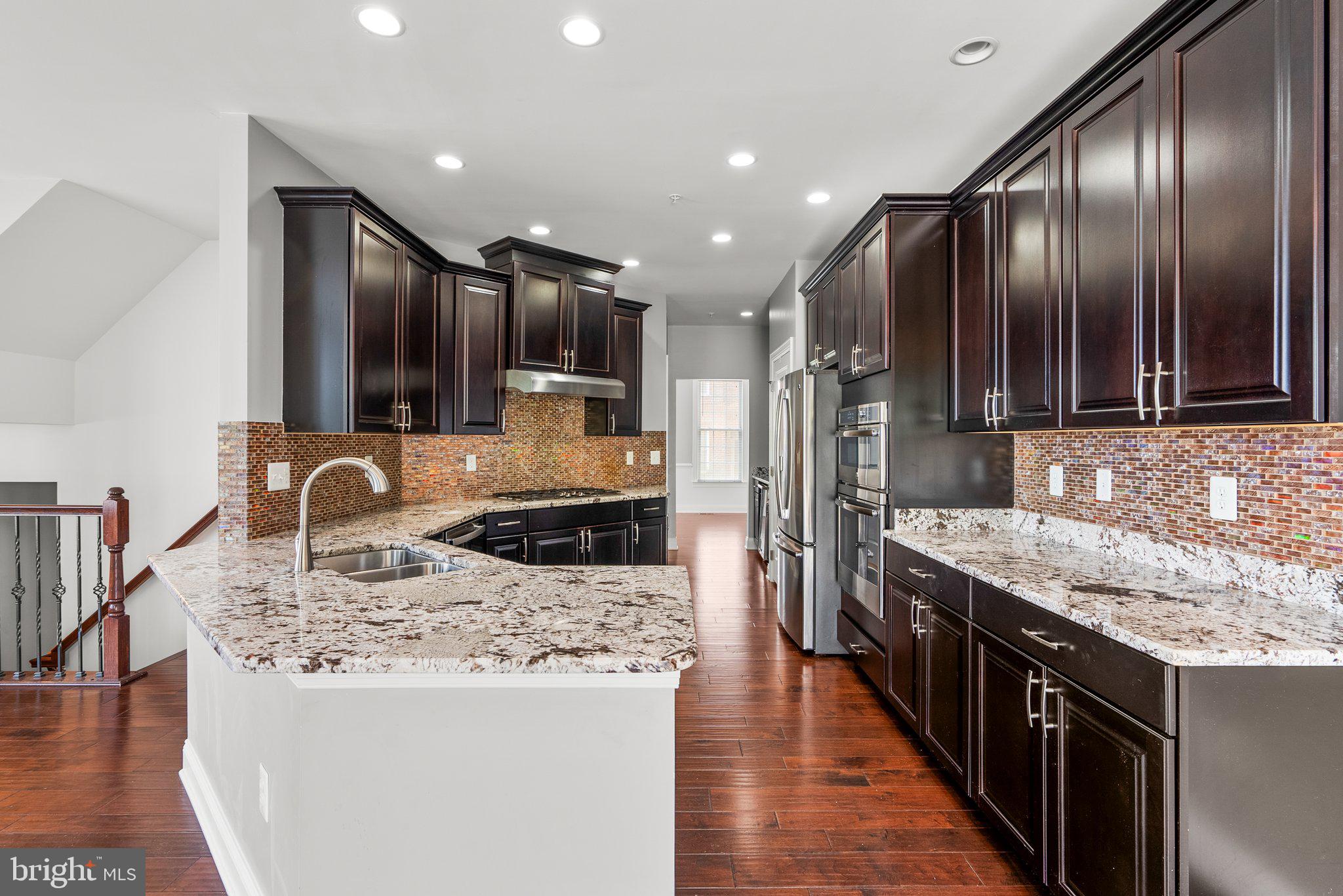 2501 Cherry Tree Road Hanover, MD 21076 - Photo 10 of 30 a kitchen with stainless steel appliances granite countertop a sink stove and refrigerator