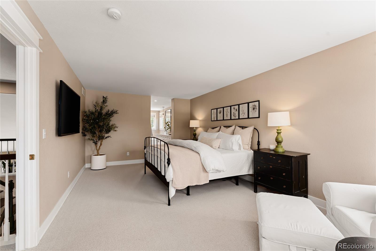 9441 South Hackberry Lane Highlands Ranch, CO 80129 - Photo 28 of 50 a bedroom with a bed and a flat screen tv