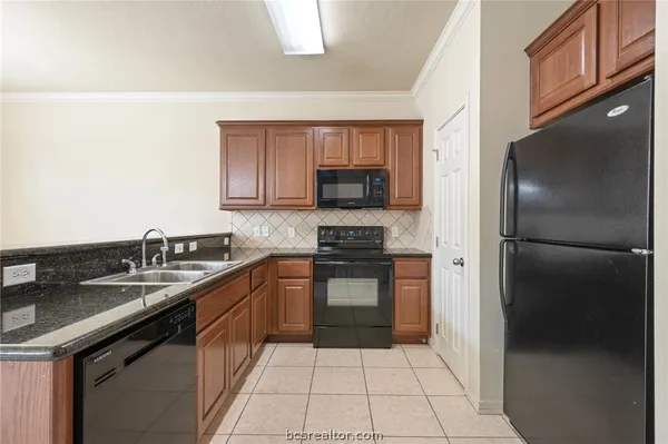 a kitchen with a sink a stove and refrigerator