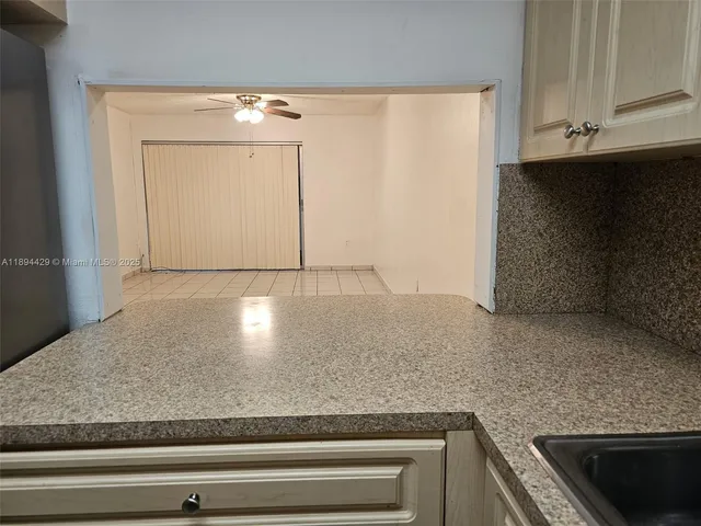 a kitchen with stainless steel appliances a refrigerator sink and cabinets