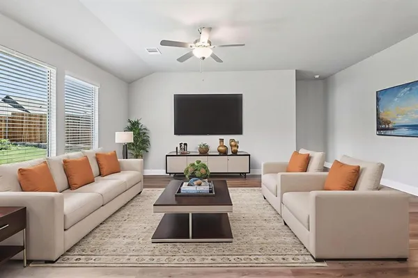 a living room with furniture and a flat screen tv