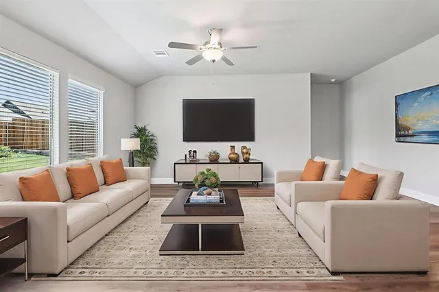 a living room with furniture and a flat screen tv