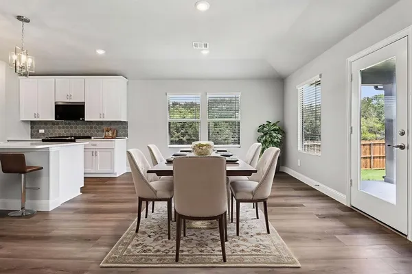 a dining room with furniture a window and a kitchen view