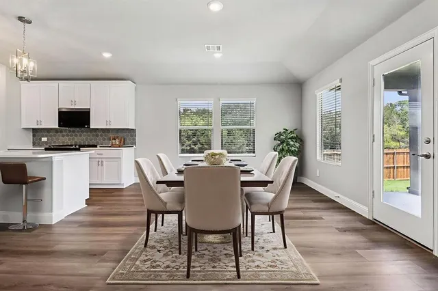 a dining room with furniture a window and a kitchen view