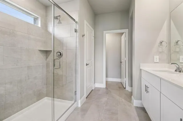 a bathroom with a shower and a sink