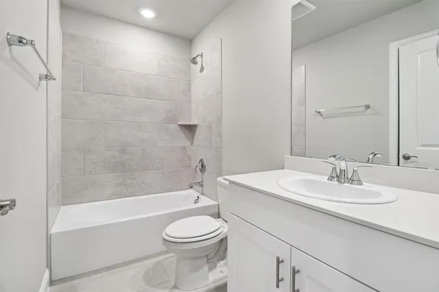 a bathroom with a sink a toilet and bathtub