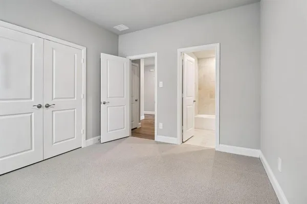 an empty room with closet area