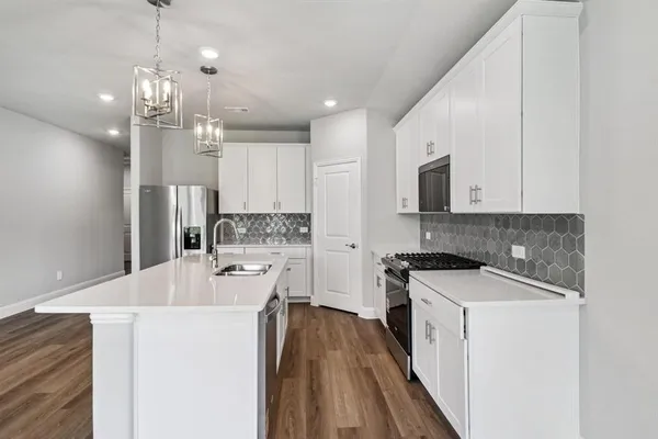 a kitchen with a sink stove and refrigerator