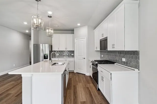 a kitchen with a sink stove and refrigerator