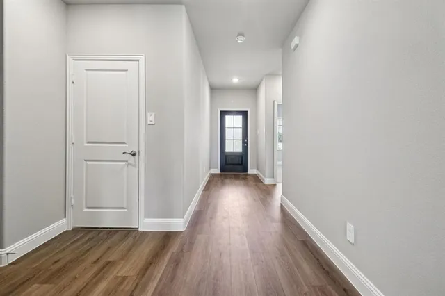 a view of hallway with wooden floor