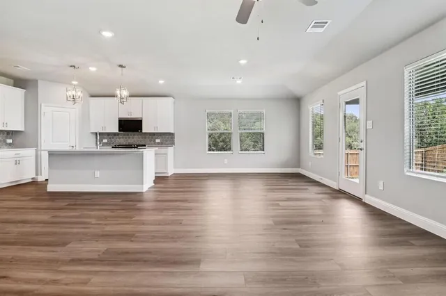 a view of kitchen with sink and wooden floor