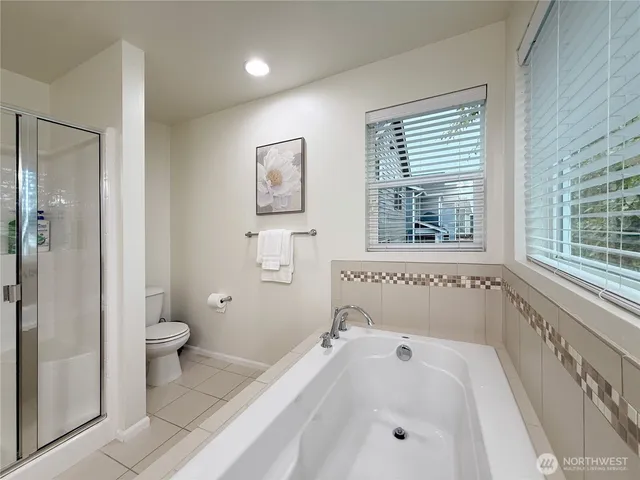 a bedroom with a bed desk and a window