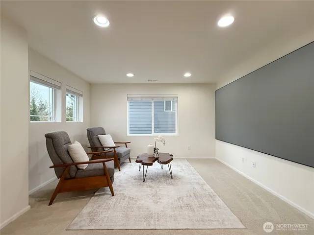 a living room with furniture a rug and a window