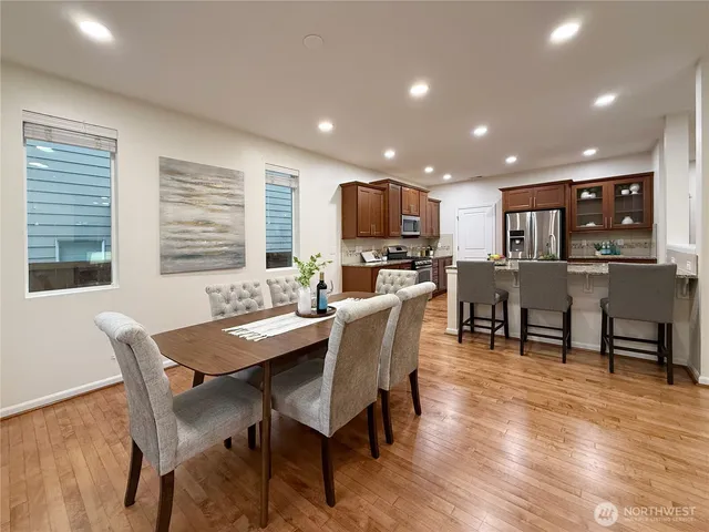a view of a dining room with furniture and wooden floor