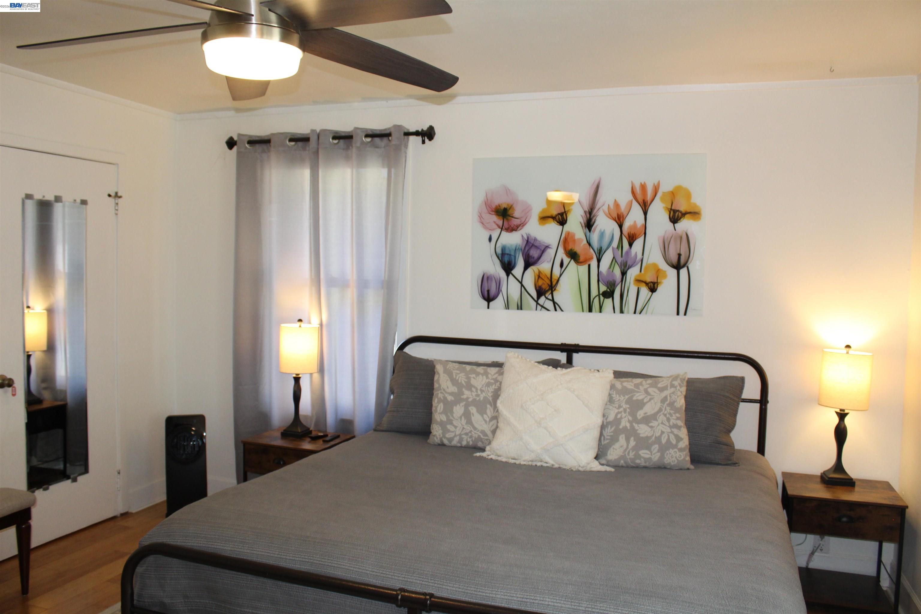 536 Williams Street Murphys, CA 95247 - Photo 13 of 24 a bed room with a bed and a painting on the wall
