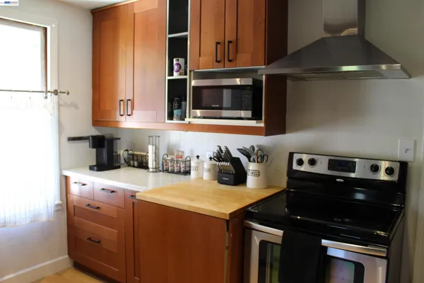 a bathroom with a granite countertop sink and a window