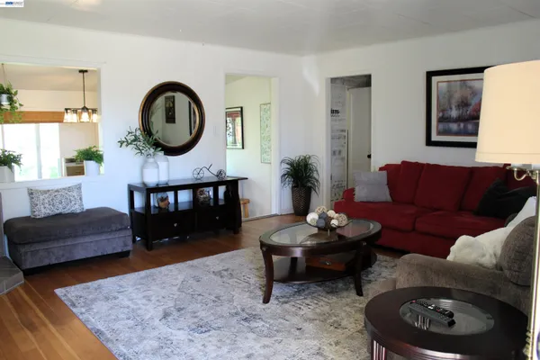 a living room with furniture and a large mirror