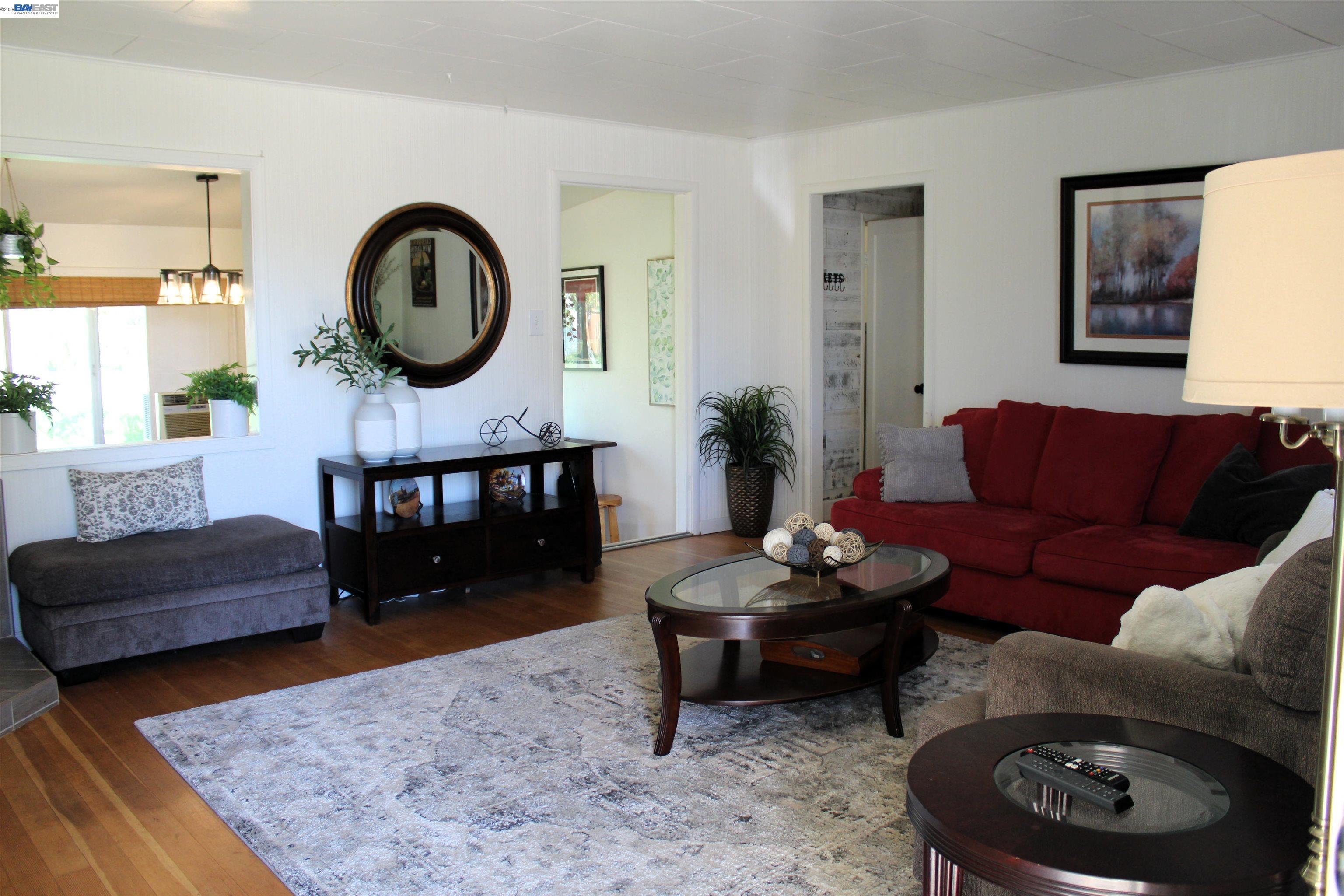 536 Williams Street Murphys, CA 95247 - Photo 2 of 24 a living room with furniture a rug and a mirror