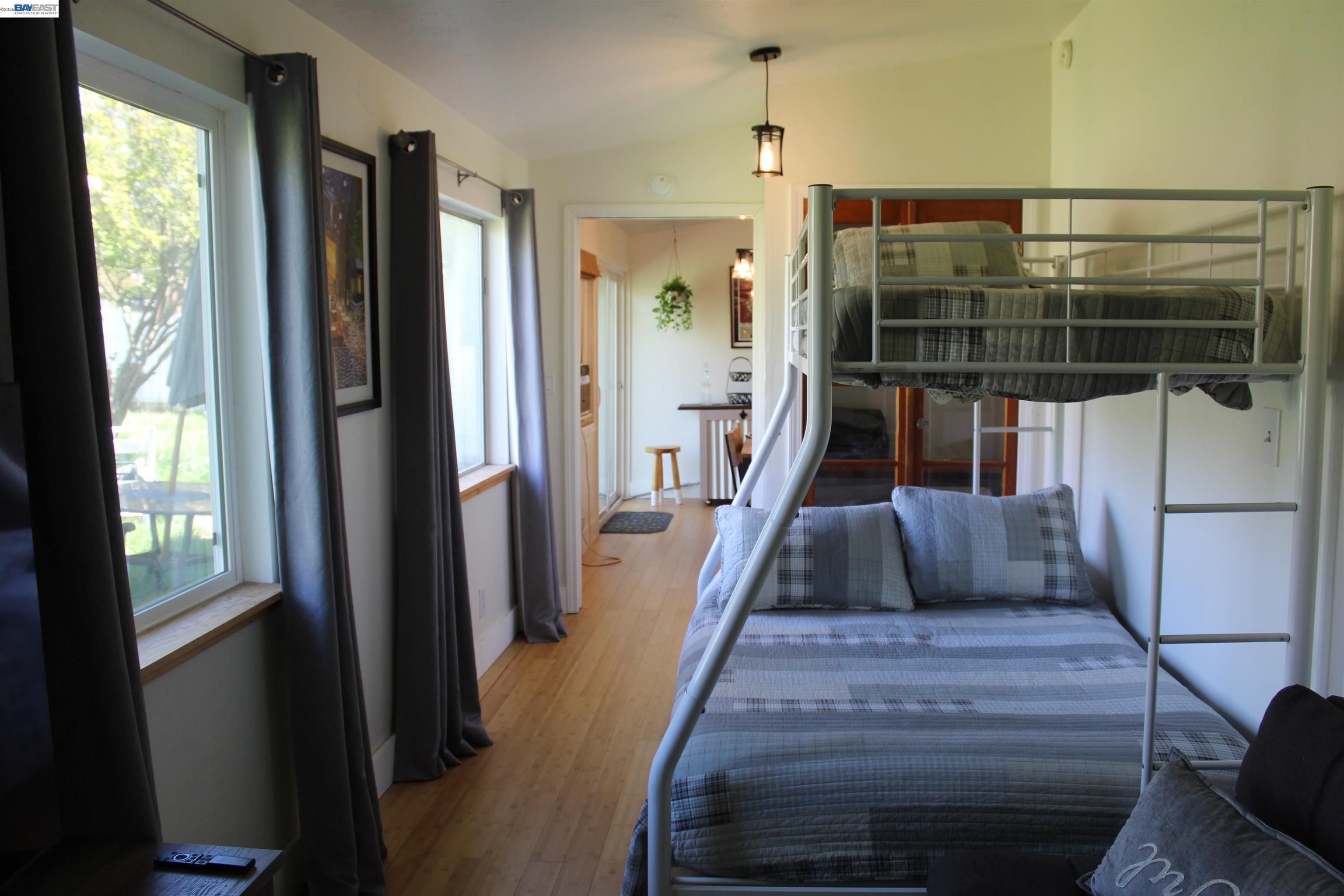536 Williams Street Murphys, CA 95247 - Photo 9 of 24 a bedroom with a bed and a wooden floor