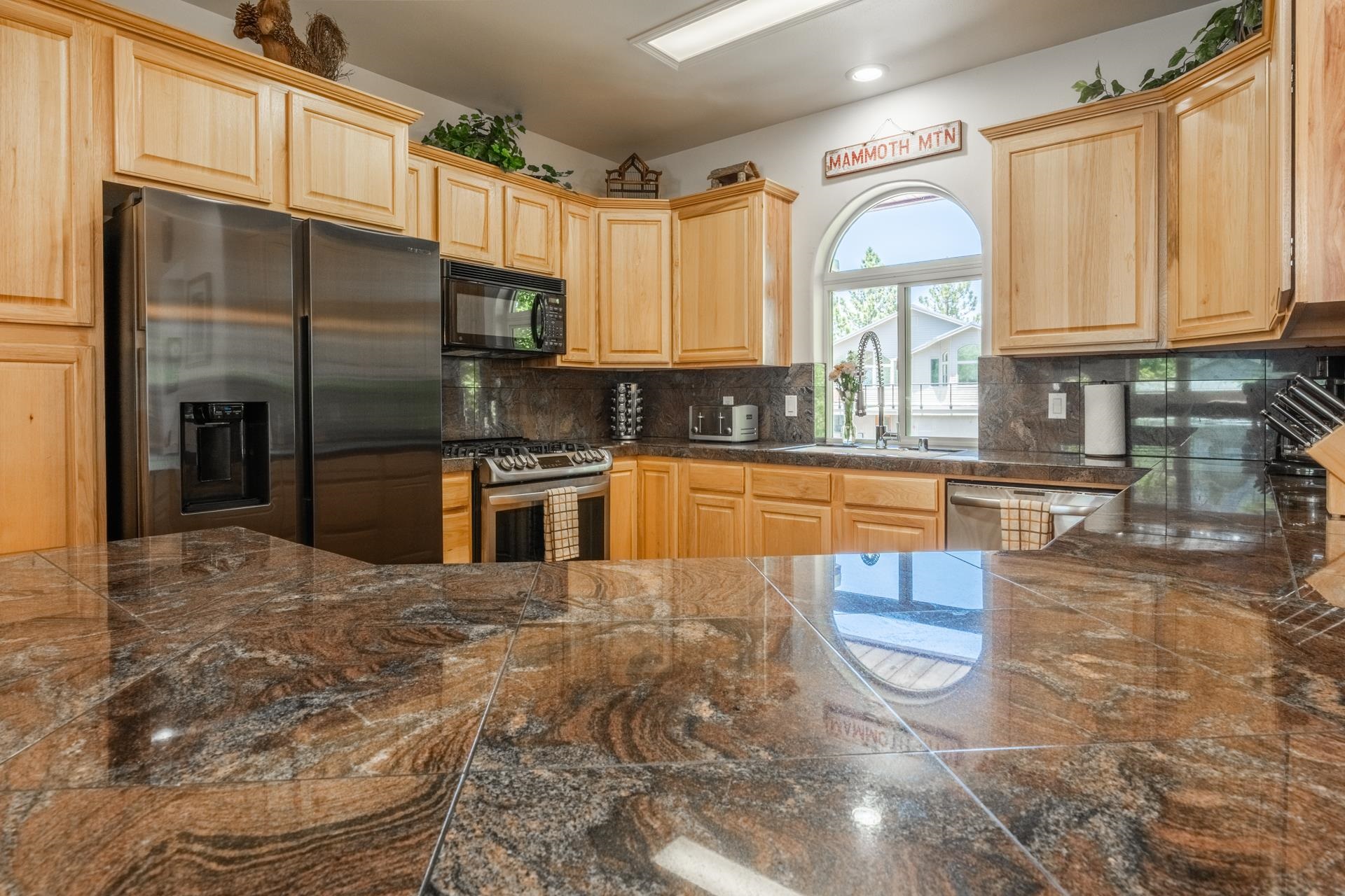 372 Wagon Wheel Road Mammoth Lakes, CA 93546 - Photo 9 of 50 a kitchen with stainless steel appliances granite countertop a stove a sink and a microwave