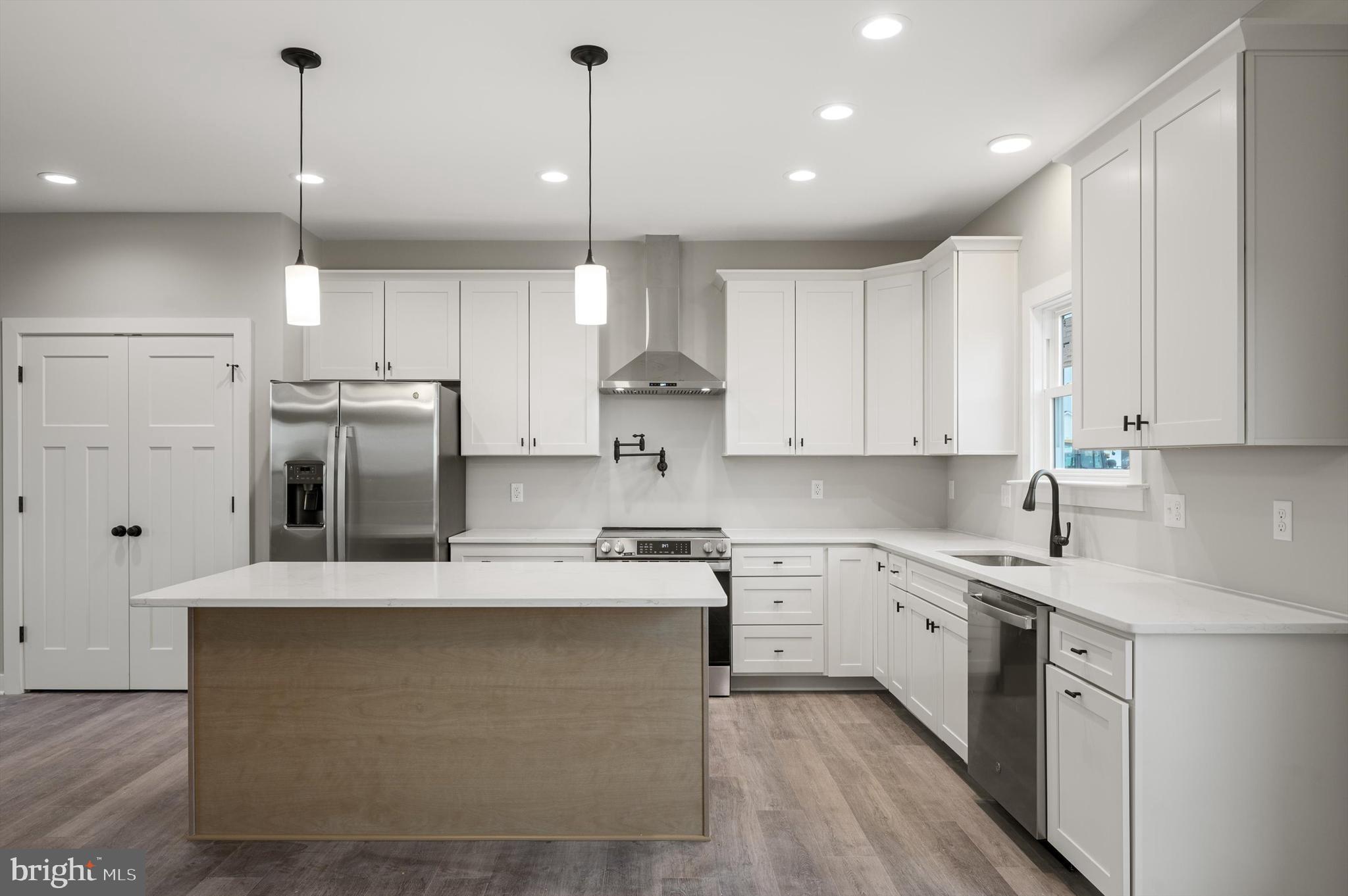 309 Gun Club Road Stephenson, VA 22656 - Photo 11 of 41 a large kitchen with stainless steel appliances granite countertop a sink a stove and a refrigerator