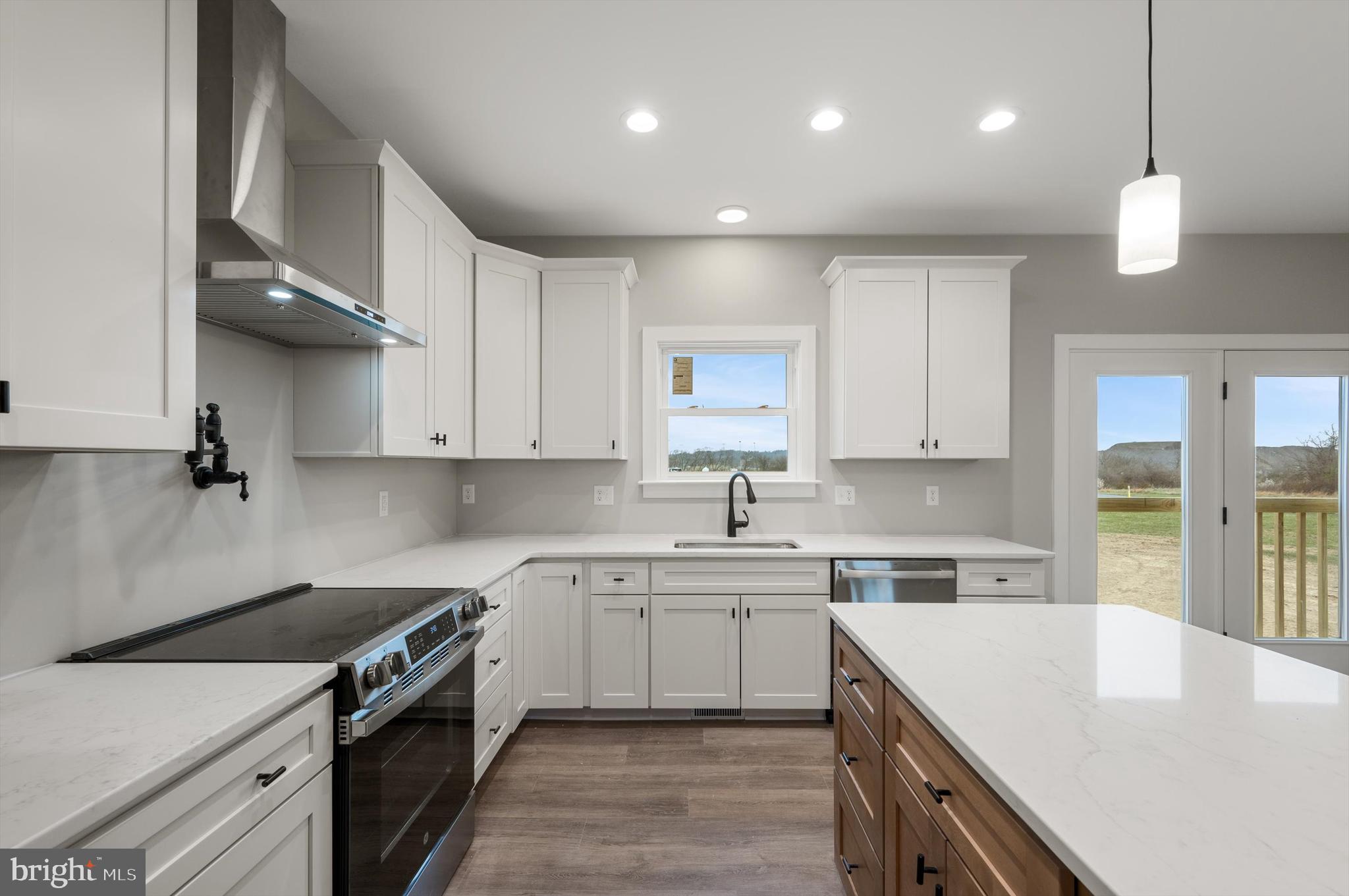 309 Gun Club Road Stephenson, VA 22656 - Photo 13 of 41 a kitchen with a sink a stove and cabinets