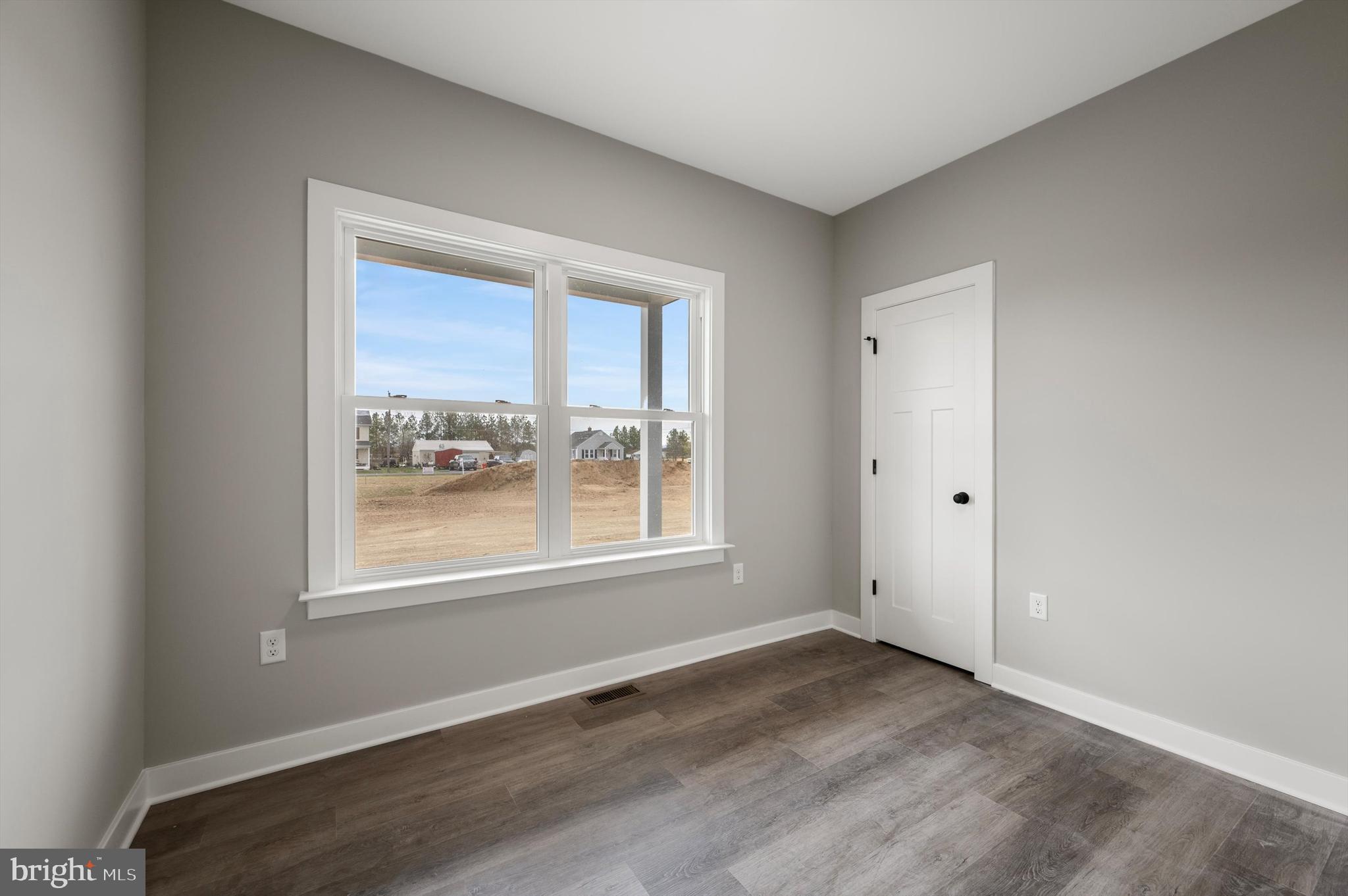 309 Gun Club Road Stephenson, VA 22656 - Photo 21 of 41 an empty room with wooden floor and windows