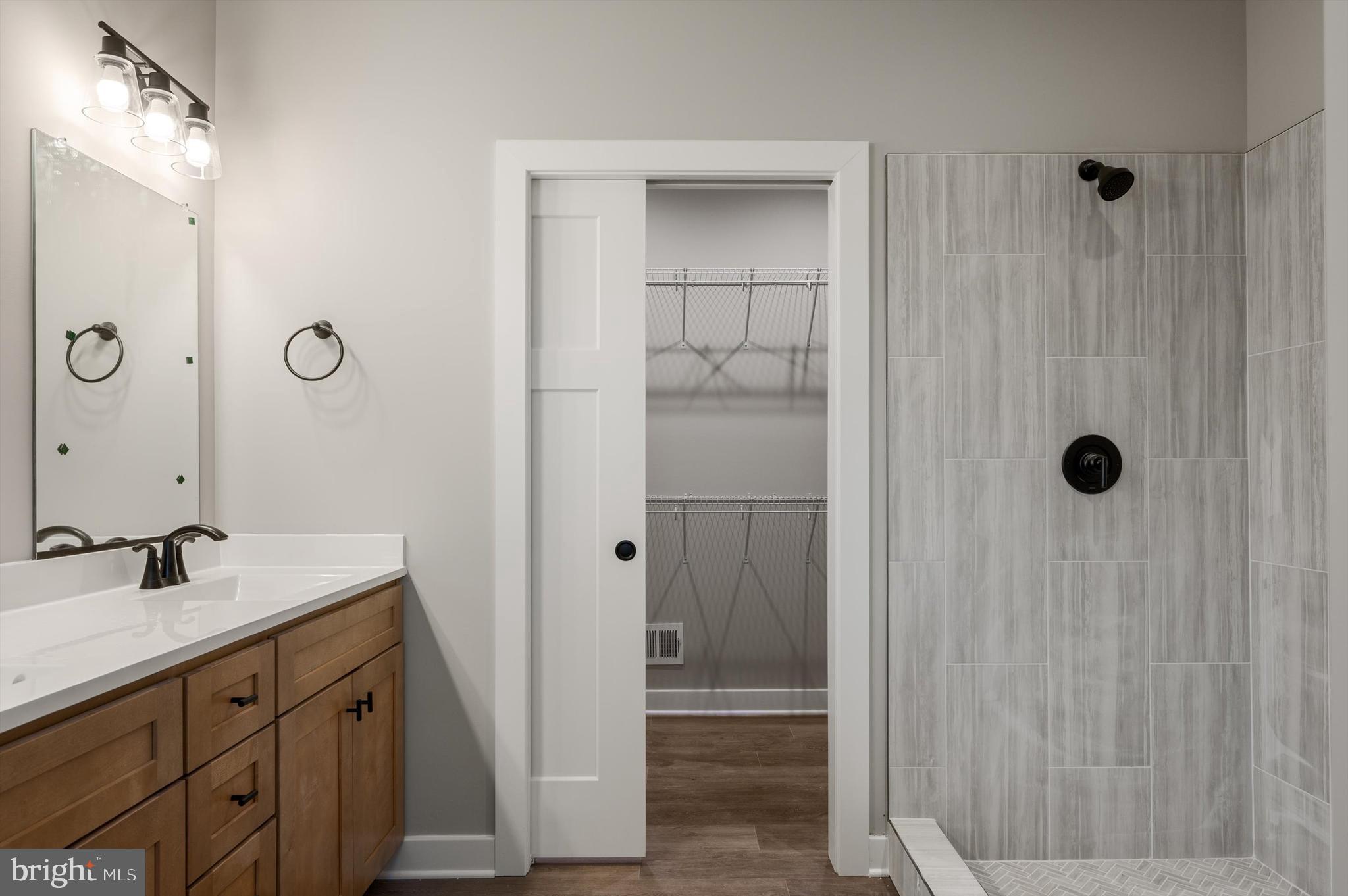 309 Gun Club Road Stephenson, VA 22656 - Photo 28 of 41 a bathroom with a shower sink and mirror