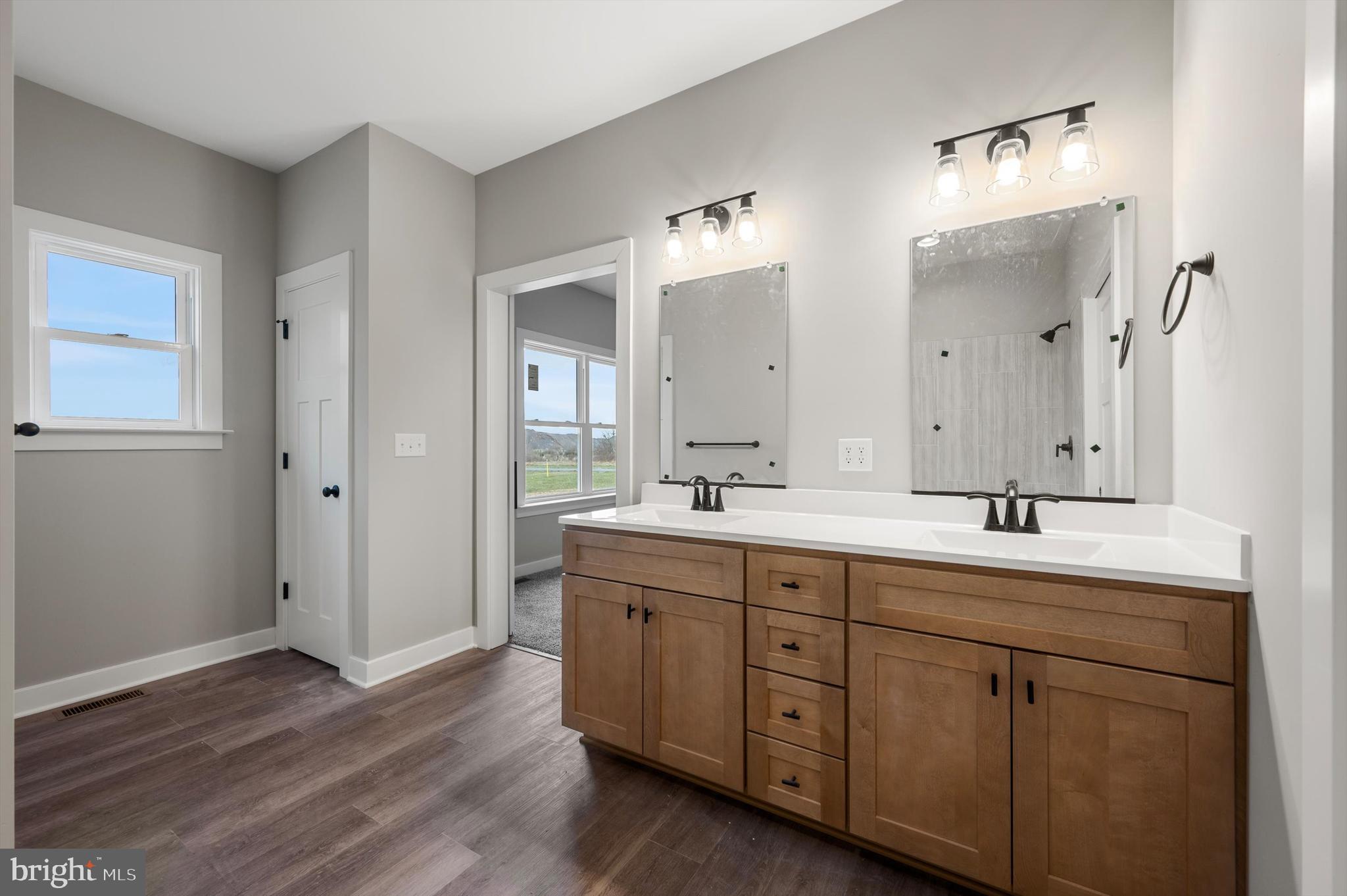 309 Gun Club Road Stephenson, VA 22656 - Photo 32 of 41 a bathroom with a double vanity sink and mirror with shower