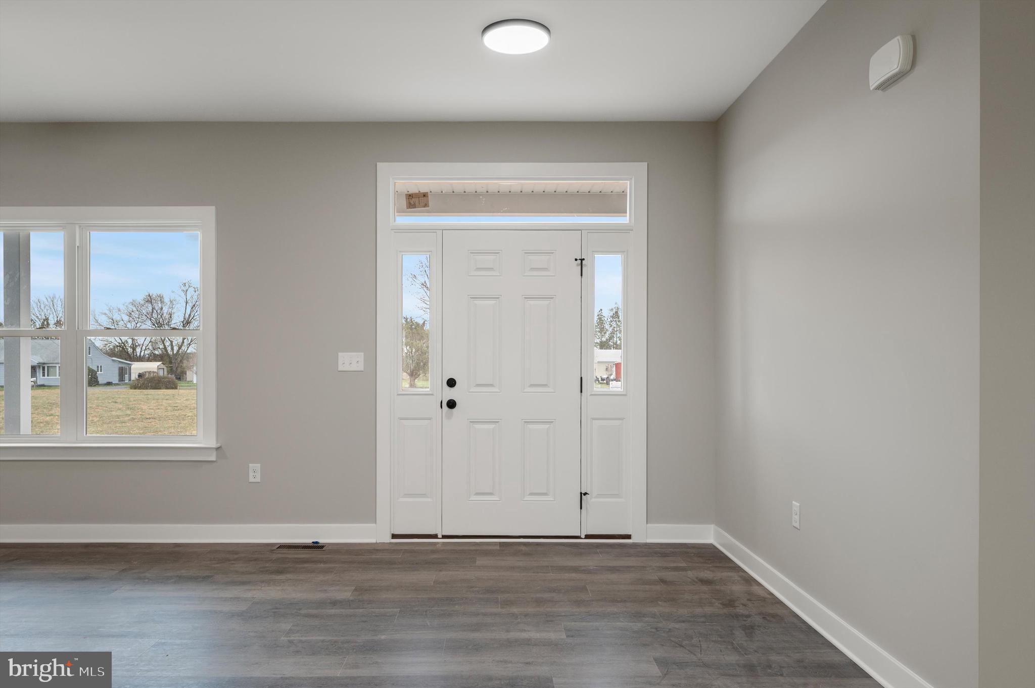 309 Gun Club Road Stephenson, VA 22656 - Photo 4 of 41 an empty room with wooden floor and windows