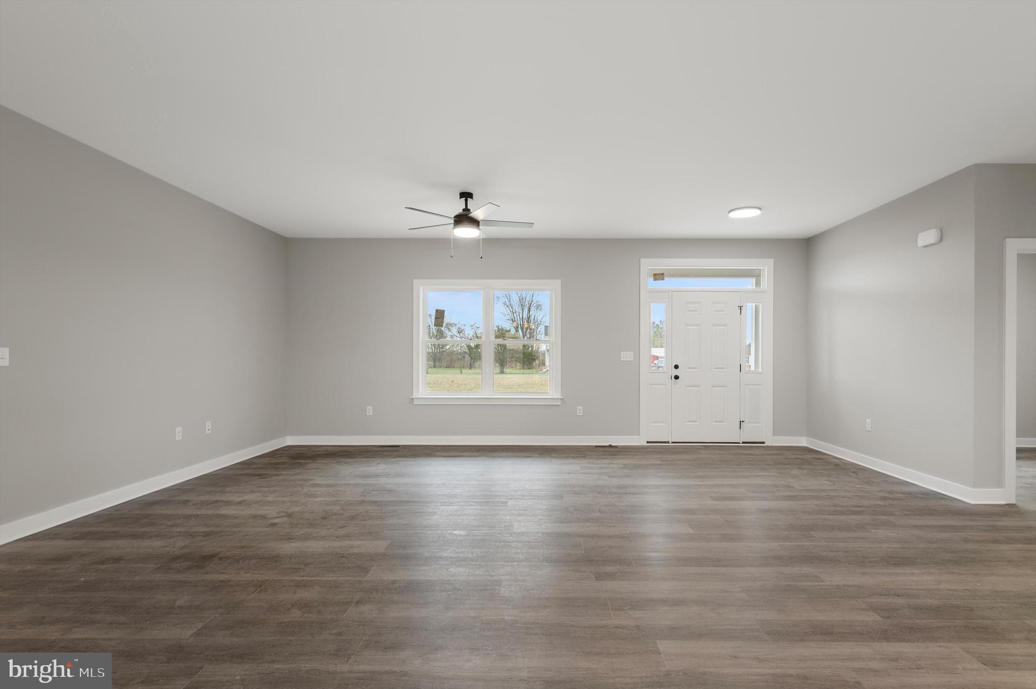 309 Gun Club Road Stephenson, VA 22656 - Photo 7 of 41 a view of an empty room with a window and wooden floor