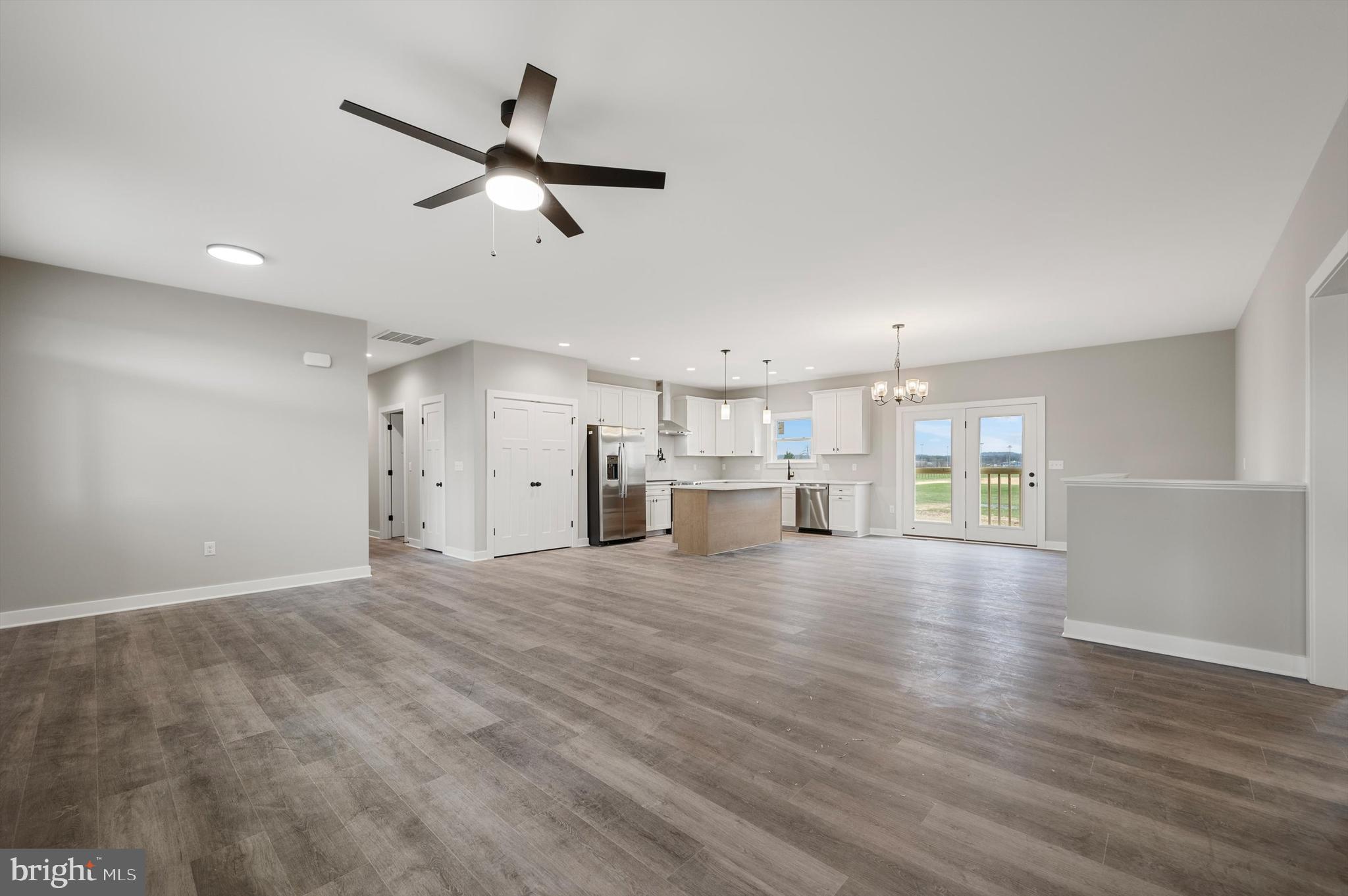 309 Gun Club Road Stephenson, VA 22656 - Photo 8 of 41 a view of empty room with wooden floor and ceiling fan