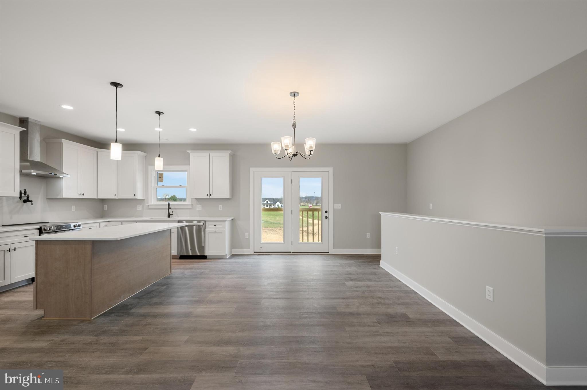 309 Gun Club Road Stephenson, VA 22656 - Photo 9 of 41 a large kitchen with granite countertop a large counter top a sink stainless steel appliances and cabinets