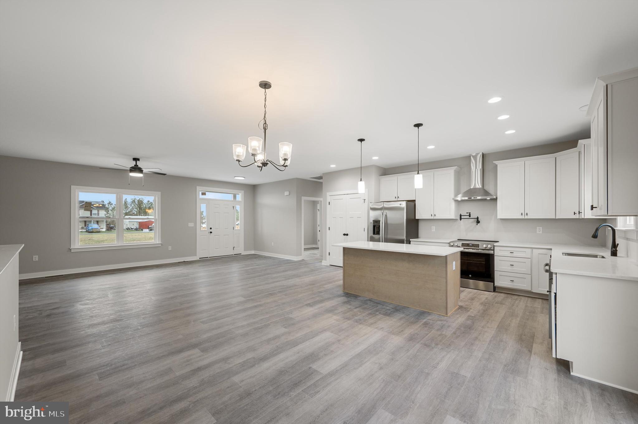 309 Gun Club Road Stephenson, VA 22656 - Photo 10 of 41 a large kitchen with cabinets wooden floor and stainless steel appliances