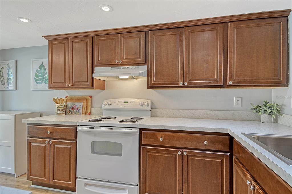 5246 Marsh Field Lane, Unit 1 Sarasota, FL 34235 - Photo 11 of 49 a kitchen with granite countertop cabinets and white appliances