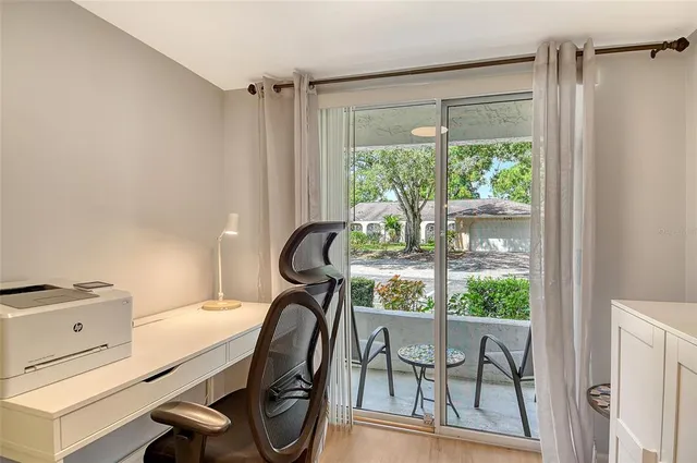 a view of a room that has a bed and a table in it