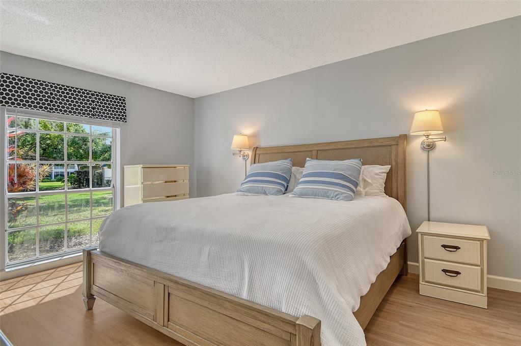 5246 Marsh Field Lane, Unit 1 Sarasota, FL 34235 - Photo 17 of 49 a bedroom with a bed and a large window