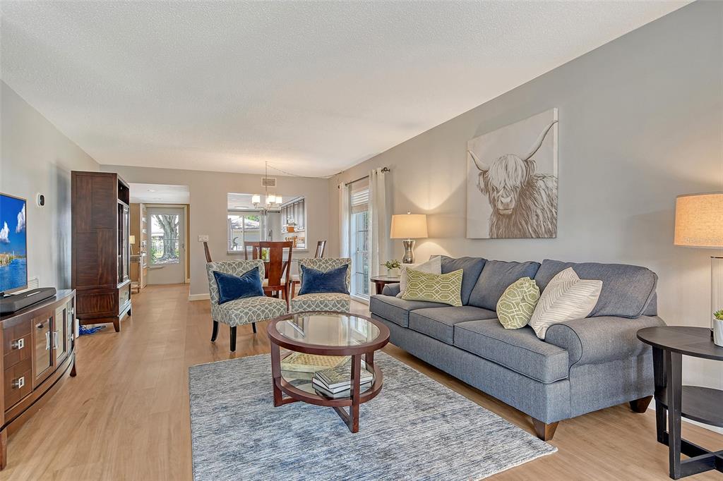 5246 Marsh Field Lane, Unit 1 Sarasota, FL 34235 - Photo 2 of 49 a living room with furniture and wooden floor
