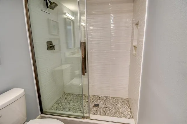 a bathroom with a glass door shower
