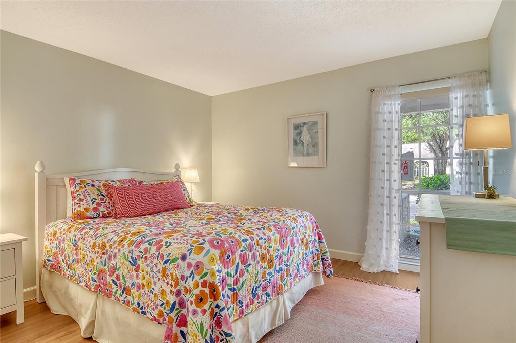 5246 Marsh Field Lane, Unit 1 Sarasota, FL 34235 - Photo 23 of 49 a bedroom with a bed and a table in it