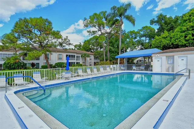 a view of a house with swimming pool and sitting area