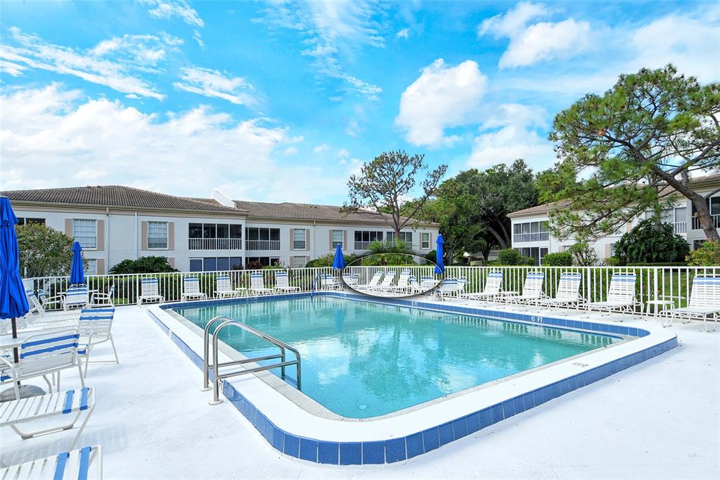 5246 Marsh Field Lane, Unit 1 Sarasota, FL 34235 - Photo 40 of 49 a view of a house with swimming pool and sitting area