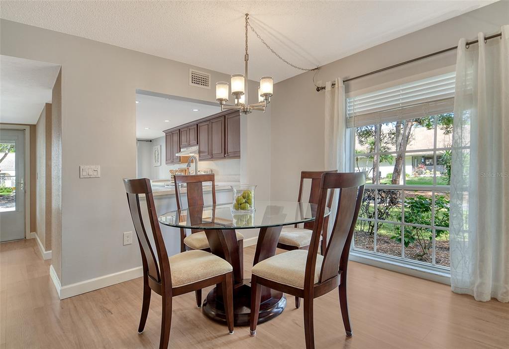 5246 Marsh Field Lane, Unit 1 Sarasota, FL 34235 - Photo 8 of 49 a view of a dining room with furniture window and wooden floor