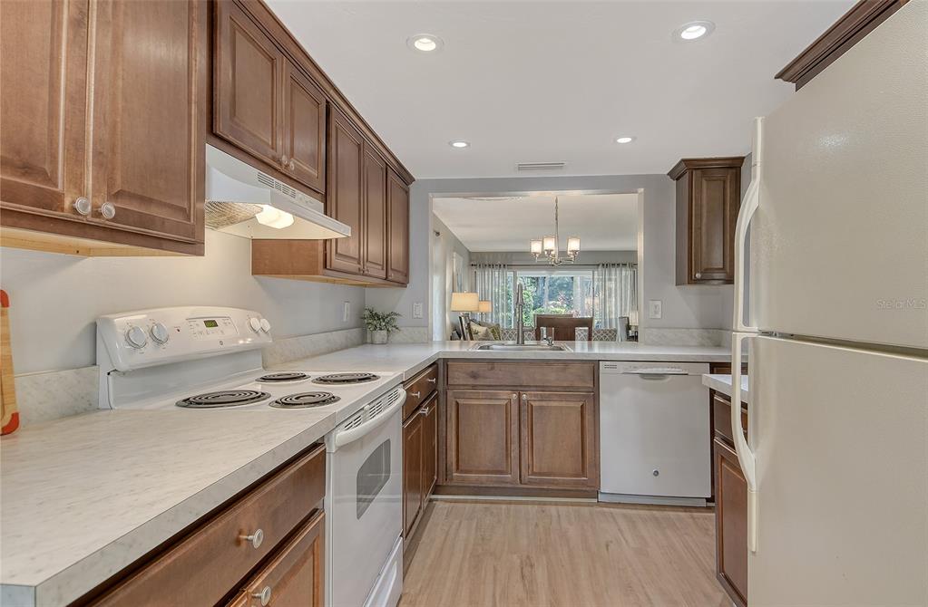 5246 Marsh Field Lane, Unit 1 Sarasota, FL 34235 - Photo 10 of 49 a kitchen with stainless steel appliances granite countertop a sink stove and refrigerator