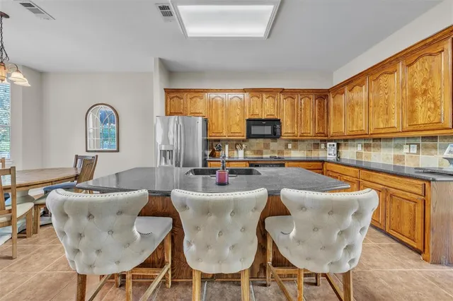 a kitchen with granite countertop lots of counter top space and furniture