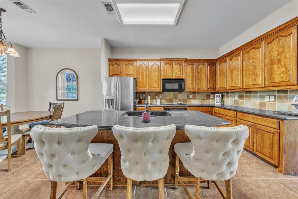 437 Rusty Run Drive Midlothian, TX 76065 - Photo 11 of 40 a kitchen with granite countertop lots of counter top space and furniture