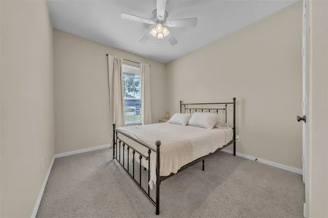 a bedroom with a bed and window