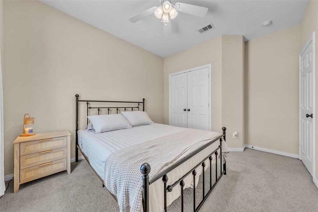 437 Rusty Run Drive Midlothian, TX 76065 - Photo 15 of 40 a bedroom with a bed and a chandelier