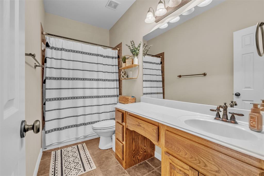 437 Rusty Run Drive Midlothian, TX 76065 - Photo 16 of 40 a bathroom with a sink toilet and shower