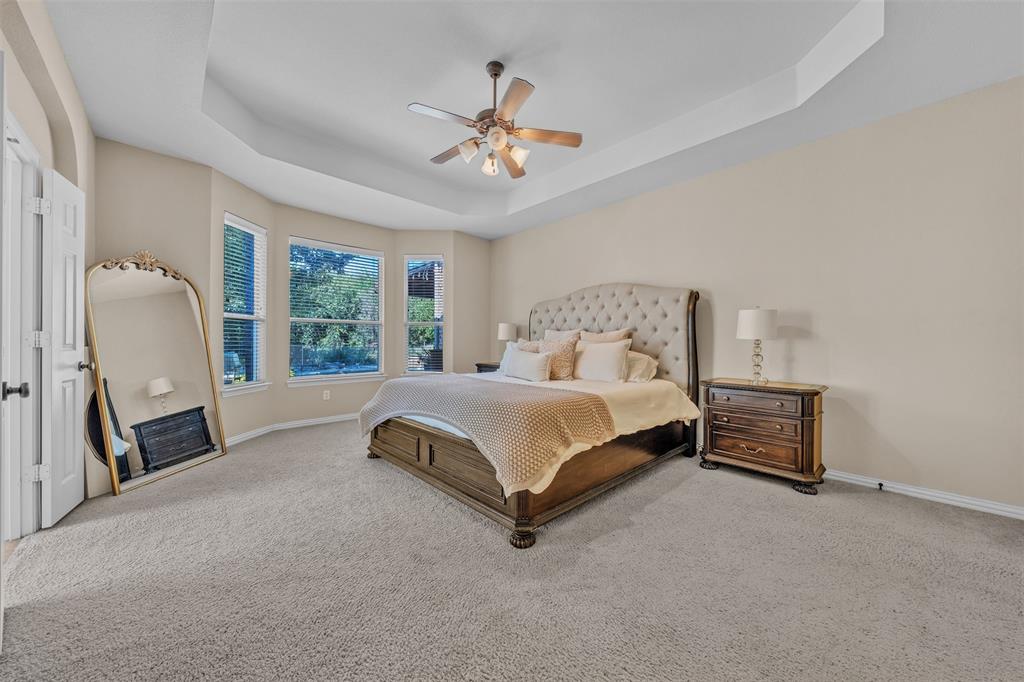 437 Rusty Run Drive Midlothian, TX 76065 - Photo 19 of 40 a spacious bedroom with a bed and a chandelier